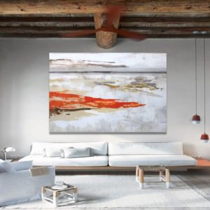 Large teal abstract art above a white sofa in a bright living room.