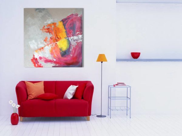Large teal abstract art above a white sofa in a bright living room.