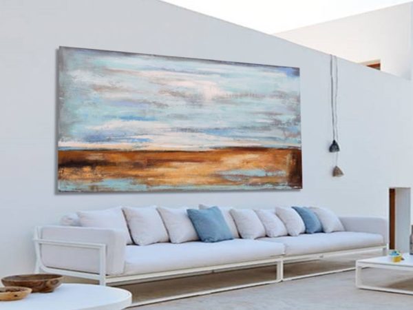 Large teal abstract art above a white sofa in a bright living room.