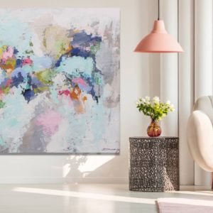 A romantic living room with a painting, soft colors, and cozy furniture.