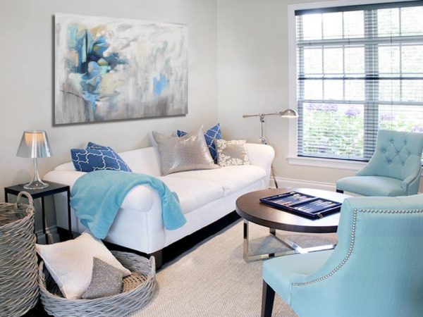 Gray abstract canvas art with lilac hints above a sofa.