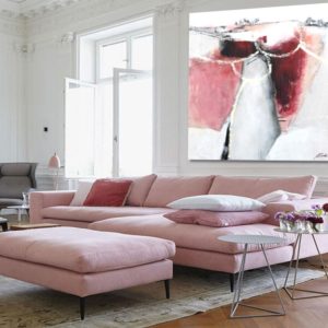 Bright living room with magenta abstract painting and cozy modern decor.