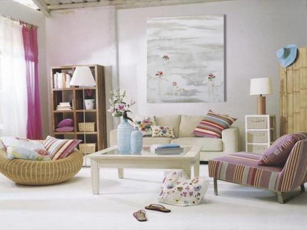 A romantic living room with a painting, soft colors, and cozy furniture.
