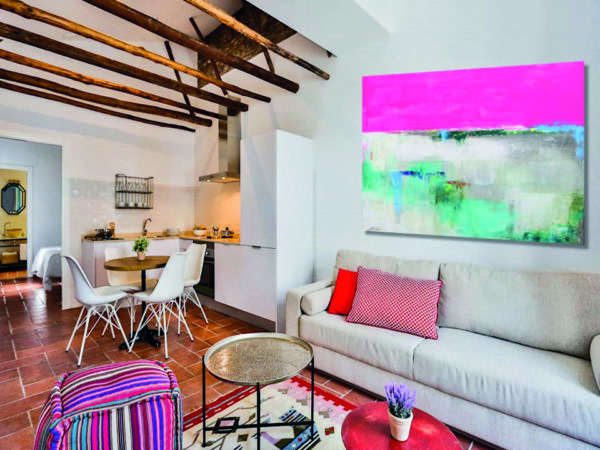 Bright living room with magenta abstract painting and cozy modern decor.
