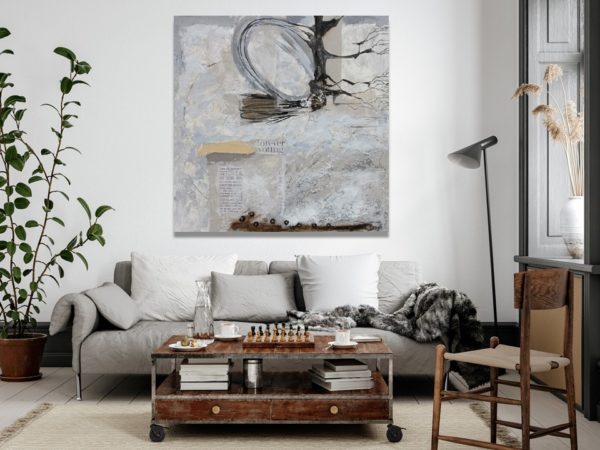 Minimalist bedroom with abstract beige painting and cactus decor.