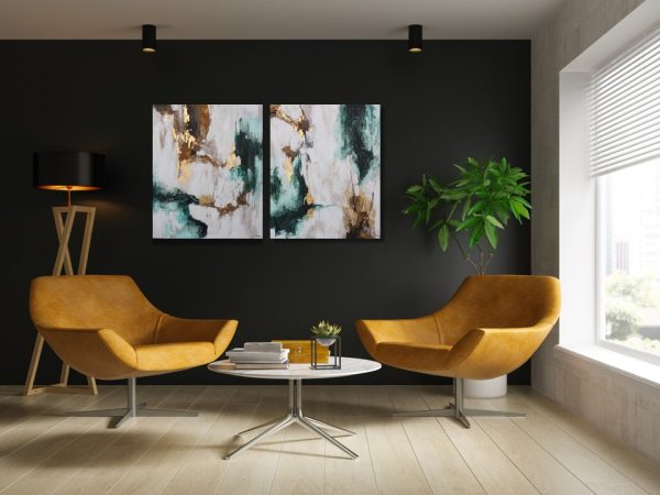 Set of two abstract hand-painted artworks in green, white, and gold tones above a modern seating area.