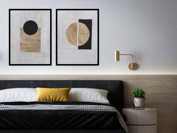 Black, white and gold geometric wall art set above a modern minimalist bed